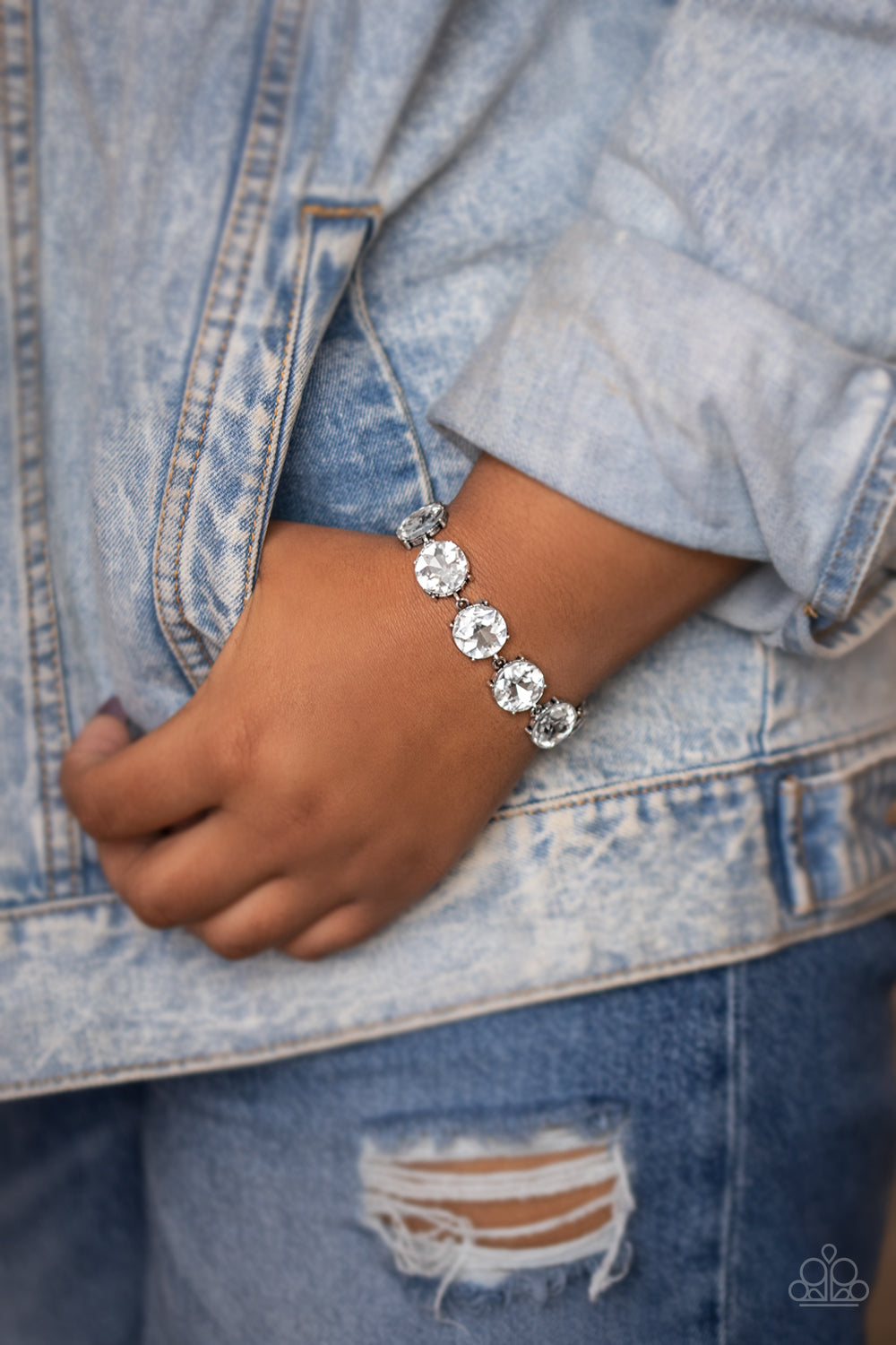 Nestled inside classic silver fittings, a collection of oversized white rhinestones delicately link around the wrist for a flashy finish. Features an adjustable clasp closure.  Sold as one individual bracelet.  New Kit